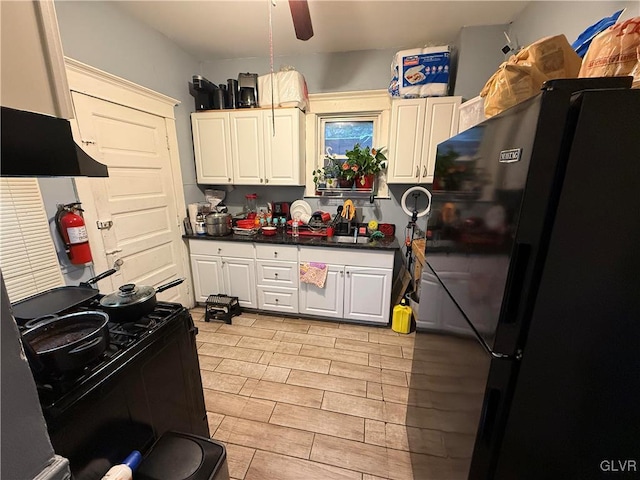 kitchen with black appliances, ceiling fan, and sink