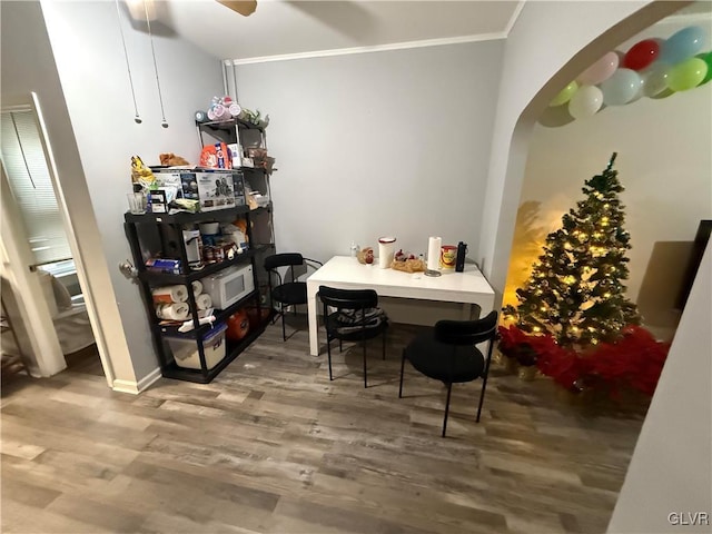 dining room featuring hardwood / wood-style flooring and ornamental molding