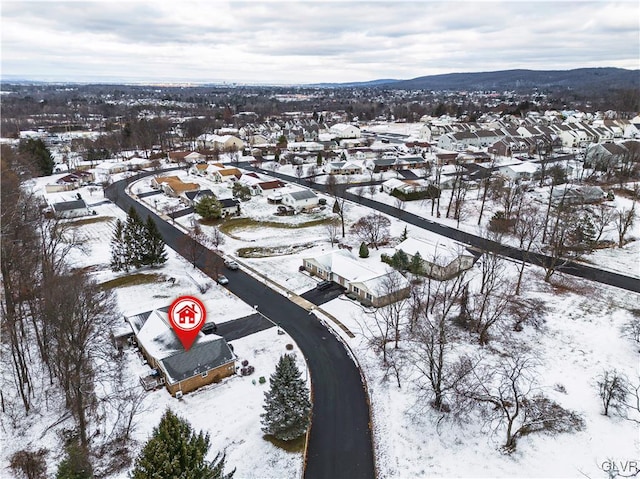 snowy aerial view featuring a mountain view