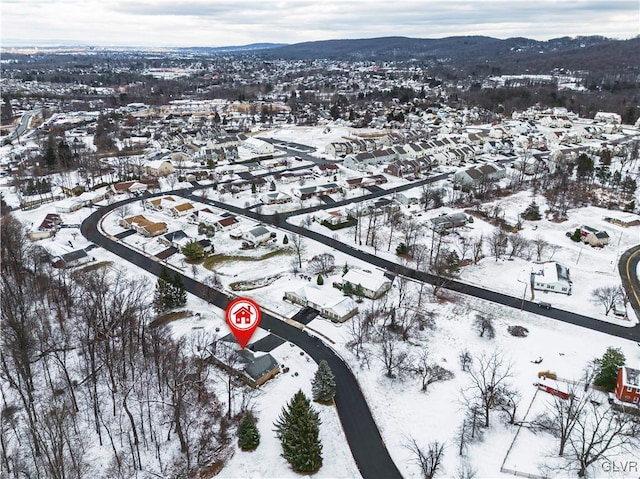 snowy aerial view with a mountain view