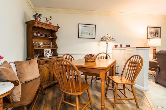 dining area with hardwood / wood-style floors and ornamental molding