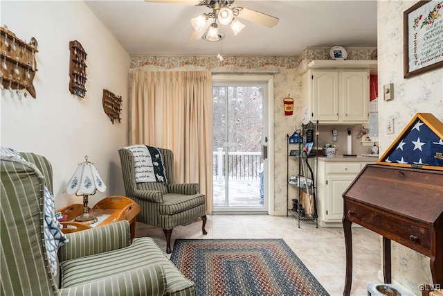 living area with ceiling fan and light tile patterned floors