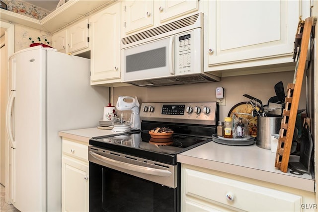 kitchen with white cabinetry and white appliances