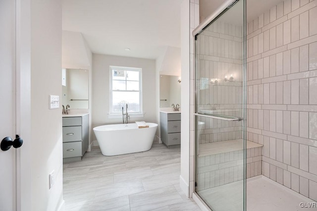 bathroom with vanity and shower with separate bathtub