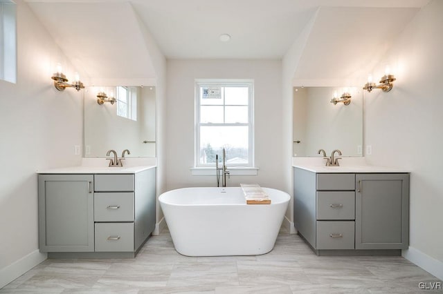 bathroom featuring a tub and vanity