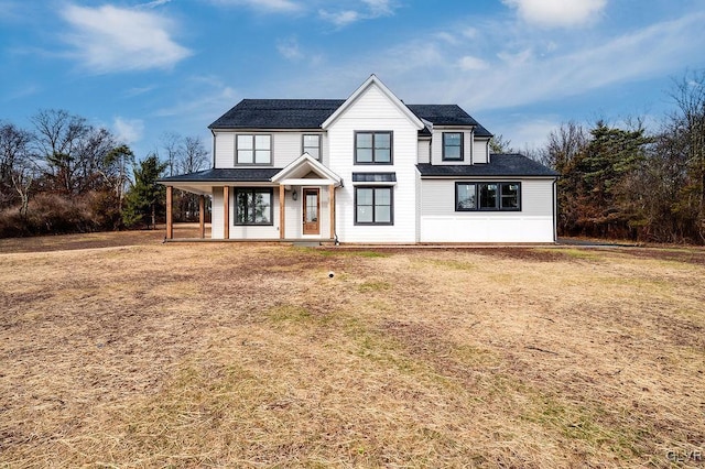 view of front of house featuring a porch and a front lawn