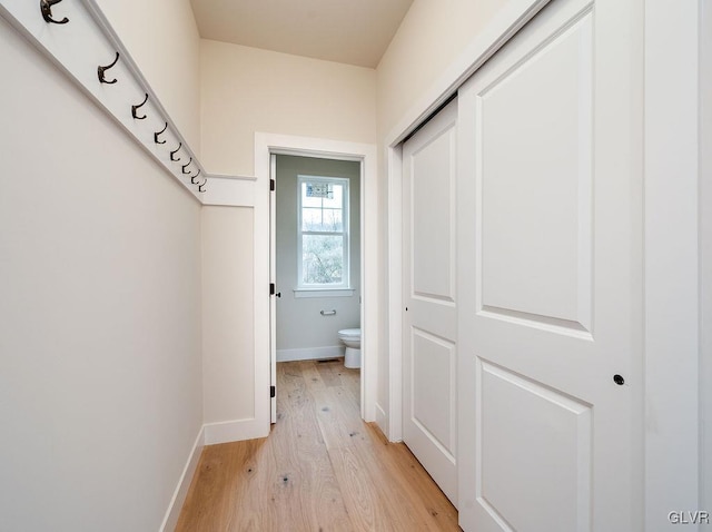 corridor with light wood-type flooring