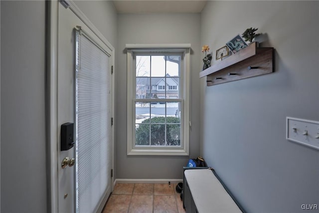 doorway with light tile patterned flooring