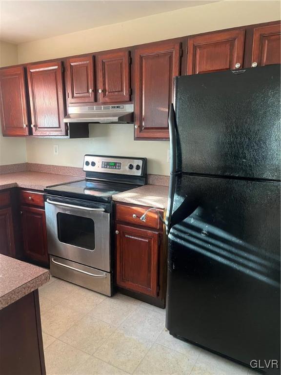 kitchen featuring stainless steel electric stove and black refrigerator