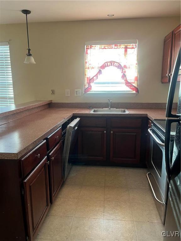 kitchen with dishwasher, sink, hanging light fixtures, kitchen peninsula, and electric stove