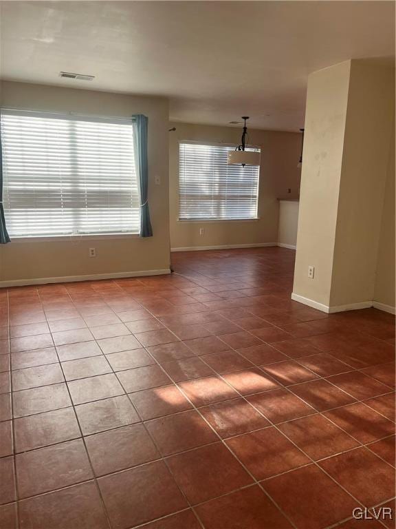 tiled empty room with plenty of natural light