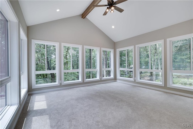 unfurnished sunroom featuring vaulted ceiling with beams, a healthy amount of sunlight, and ceiling fan