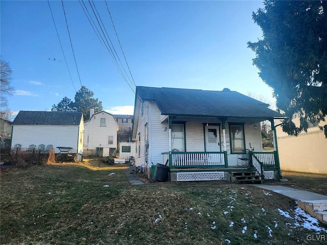 bungalow-style house with a front lawn and covered porch