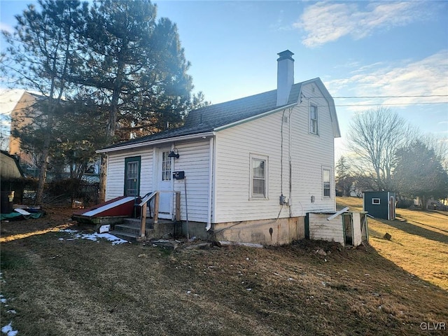 rear view of house featuring a yard