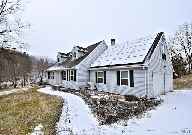 view of front facade featuring a garage and solar panels