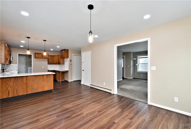 kitchen featuring a baseboard radiator, pendant lighting, dark wood-type flooring, decorative backsplash, and kitchen peninsula