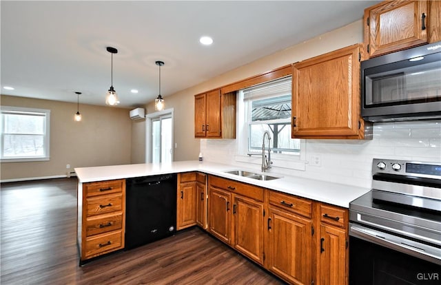 kitchen featuring dishwasher, sink, hanging light fixtures, stainless steel electric range oven, and kitchen peninsula