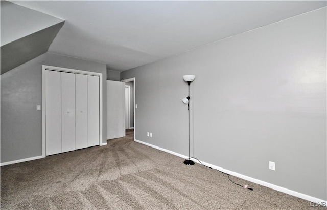 unfurnished bedroom featuring carpet floors and a closet