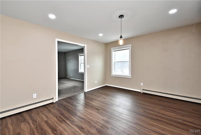 unfurnished room featuring dark wood-type flooring and a baseboard radiator