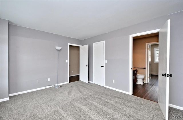 spare room featuring dark colored carpet