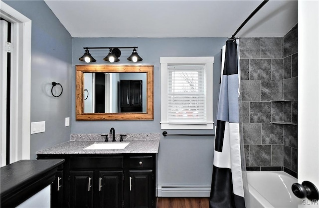 bathroom with baseboard heating, wood-type flooring, vanity, and shower / bath combination with curtain