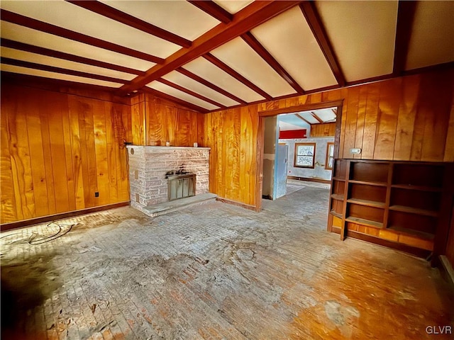 unfurnished living room with a fireplace and lofted ceiling with beams