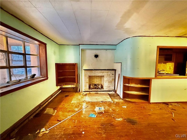 unfurnished living room featuring a stone fireplace