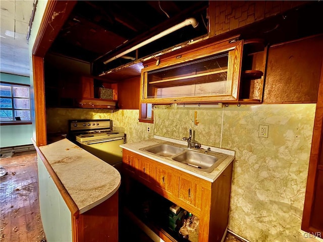 kitchen with a baseboard heating unit, stove, and sink