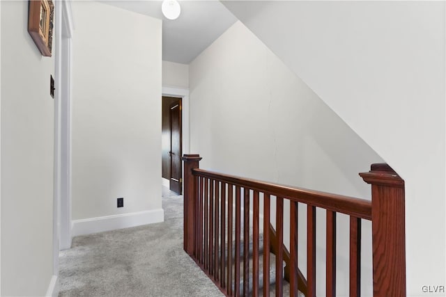 hall with light colored carpet