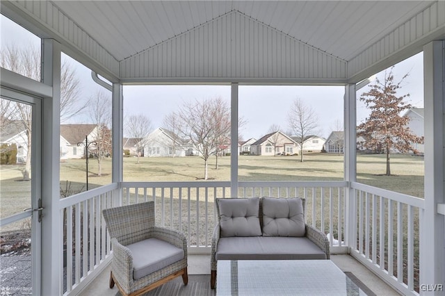 sunroom featuring vaulted ceiling