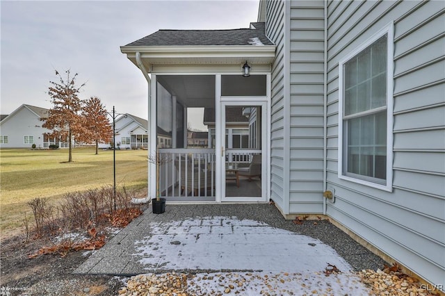 entrance to property featuring a yard