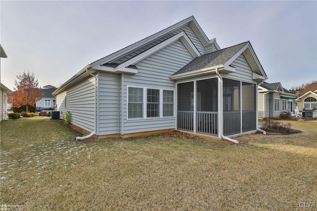 exterior space featuring a yard, central AC, and a sunroom