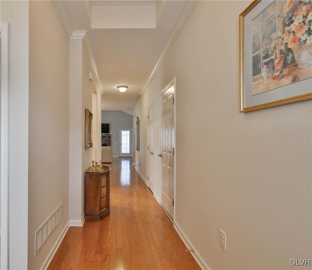 hall featuring ornamental molding and light wood-type flooring