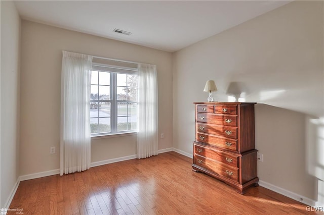 unfurnished bedroom featuring light hardwood / wood-style flooring and multiple windows