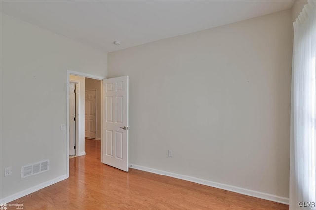 empty room with light hardwood / wood-style flooring