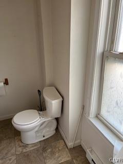 bathroom with toilet and a baseboard heating unit