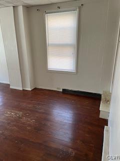 unfurnished room featuring dark hardwood / wood-style floors