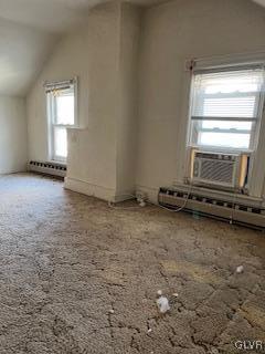 additional living space featuring lofted ceiling, cooling unit, a baseboard heating unit, and carpet flooring