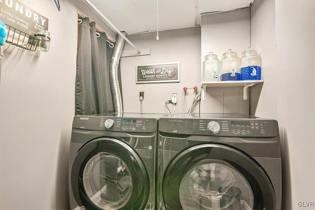 clothes washing area with washer and clothes dryer