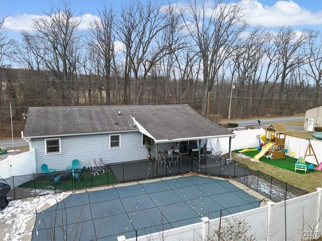 view of pool with a playground and a patio