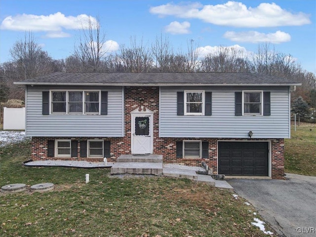 split foyer home with a front yard and a garage