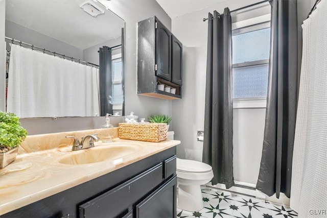 bathroom featuring toilet and vanity