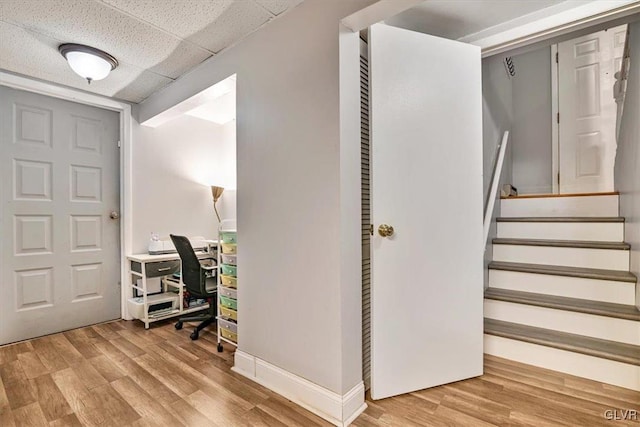 foyer entrance with a paneled ceiling and wood-type flooring