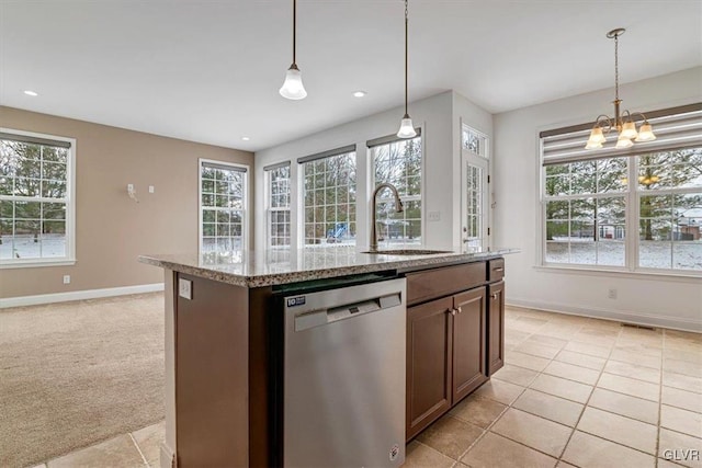 kitchen featuring decorative light fixtures, dishwasher, a chandelier, a kitchen island with sink, and light colored carpet