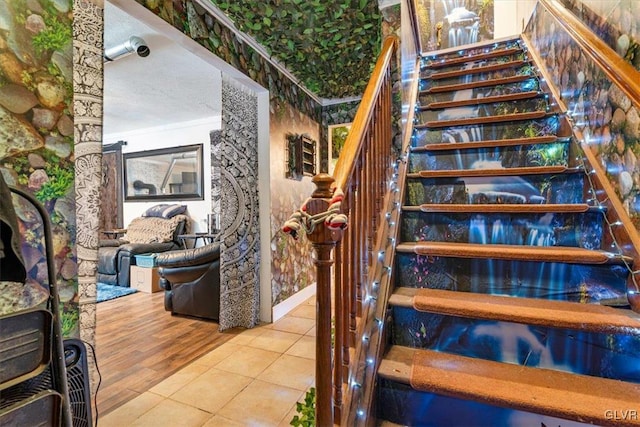 staircase featuring a textured ceiling and tile patterned floors