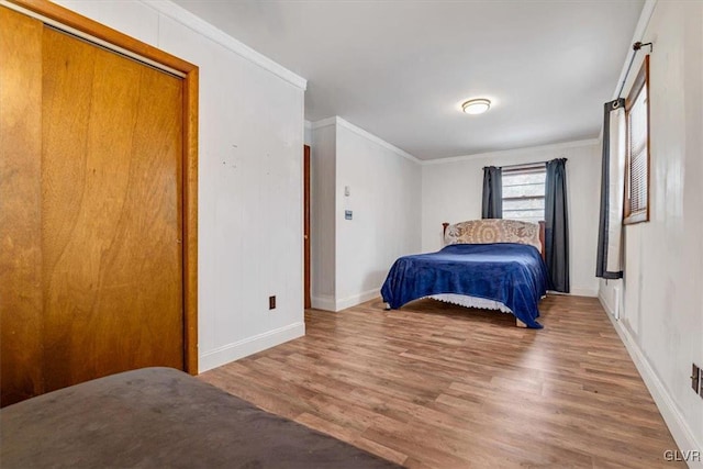 bedroom featuring hardwood / wood-style flooring, a closet, and crown molding