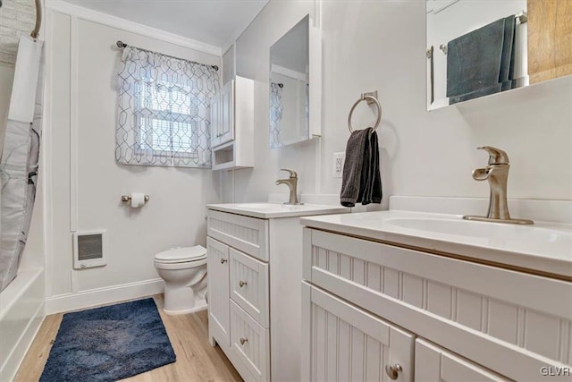 full bathroom with toilet, vanity, hardwood / wood-style floors, and shower / bath combo with shower curtain