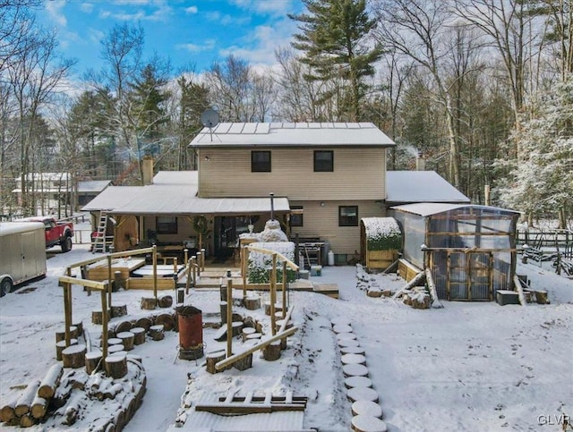 snow covered house with an outdoor structure