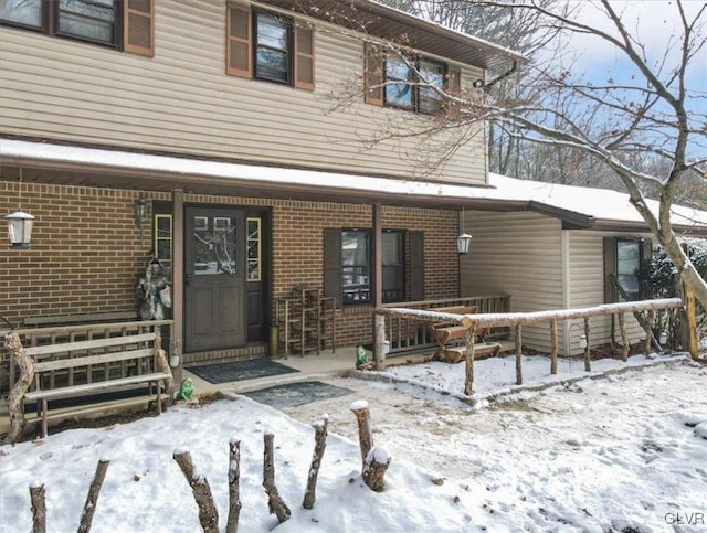 view of snow covered property entrance