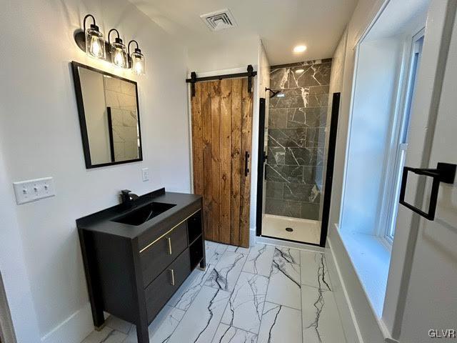 bathroom with visible vents, baseboards, marble finish floor, vanity, and a shower stall